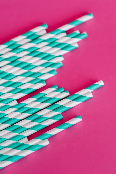 Top view of striped blue and white straws on pink — Fotografia de Stock
