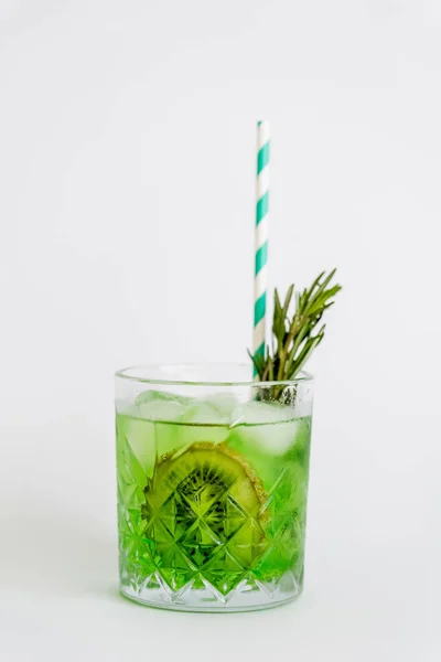 Cool faceted glass with kiwi mojito, ice cubes and rosemary isolated on white — Stock Photo