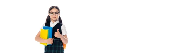 Schoolchild in eyeglasses showing like and holding books isolated on white, banner — Stock Photo