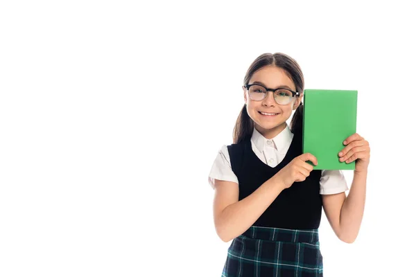 Positive schoolkid in eyeglasses holding book isolated on white — Stock Photo