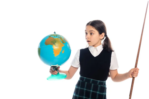 Shocked schoolgirl holding pointer and looking at globe isolated on white — Stock Photo