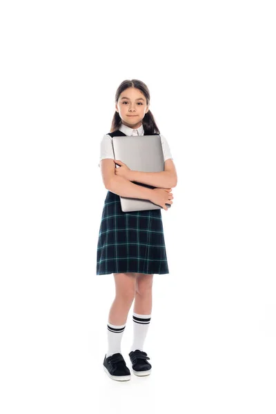 Smiling schoolkid hugging laptop and looking at camera on white background — Stock Photo
