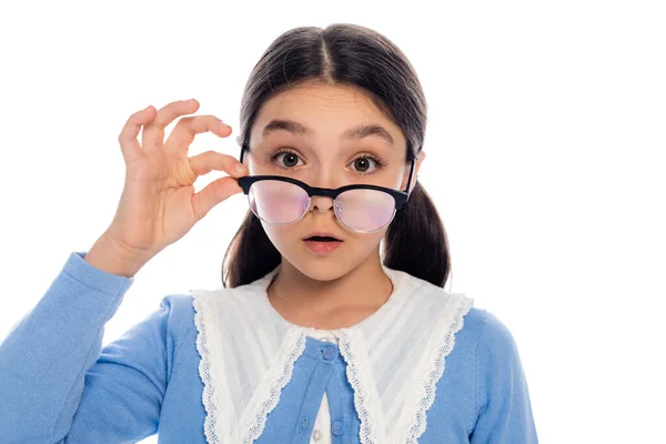 Portrait of shocked schoolkid holding eyeglasses isolated on white — Stock Photo