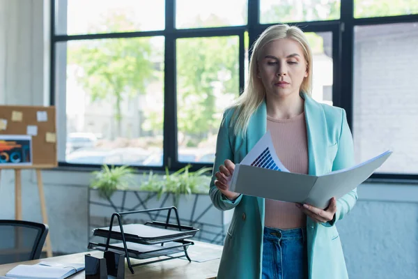 Blonde Psychologin hält Papiermappe im Beratungszimmer — Stockfoto