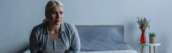 Tired blonde woman with menopause in bedroom, banner — Foto stock