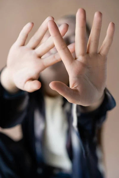 Close up view of outstretched hands of blurred woman isolated on beige — Photo de stock