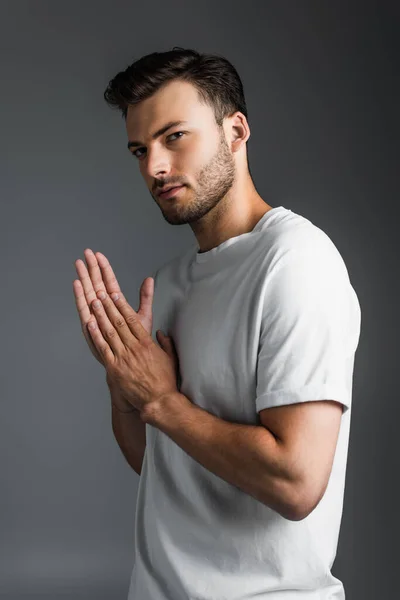 Portrait of young man in white t-shirt isolated on grey — Stock Photo