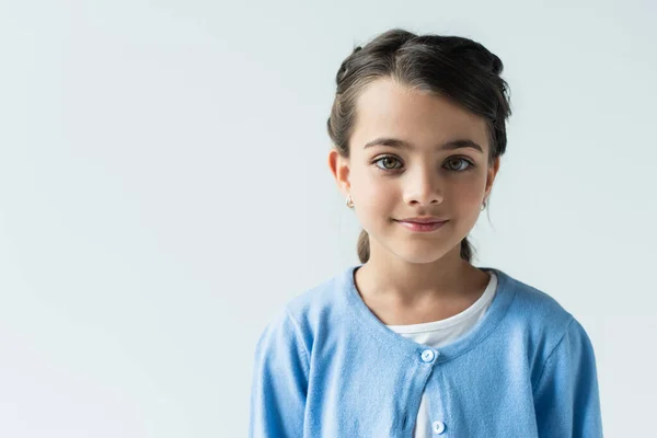 Portrait of brunette girl in blue jumper looking at camera isolated on grey — стоковое фото