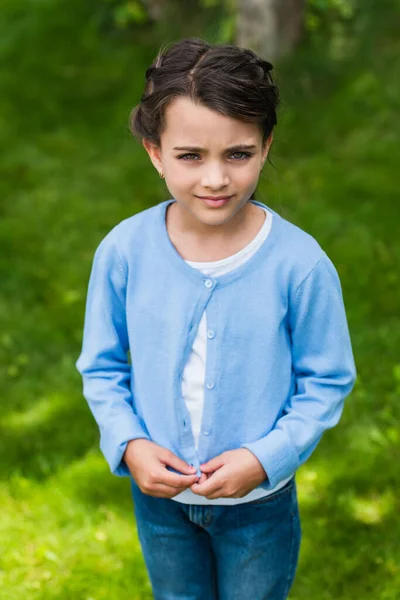 Upset ukrainian child looking at camera outdoors — Stock Photo