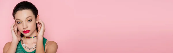 Pretty young woman with bright makeup looking at camera isolated on pink, banner — Stockfoto