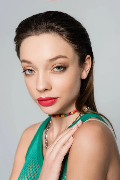 Close up view of stylish woman with red lips posing isolated on grey — стоковое фото