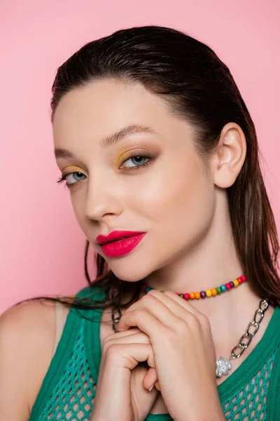 Brunette model with bright makeup posing isolated on pink — Photo de stock