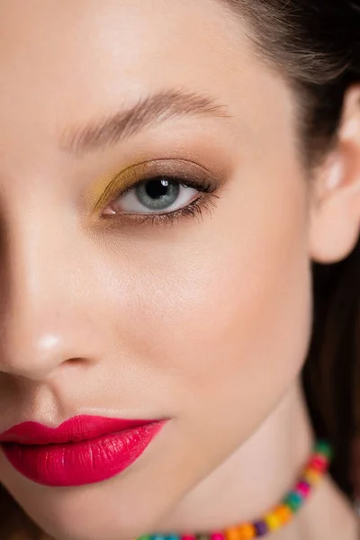 Close up of cropped young model with bright makeup looking at camera — стоковое фото