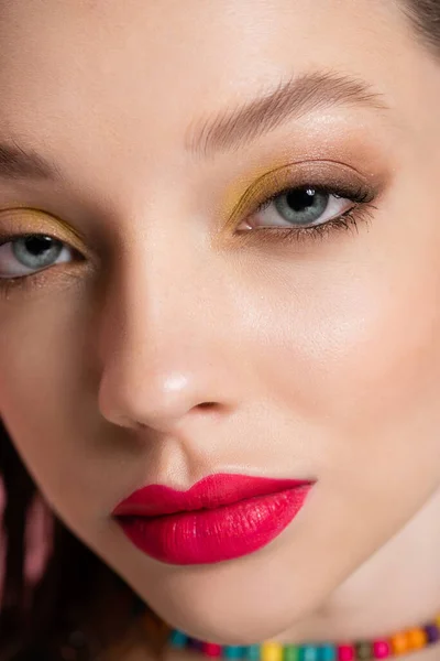 Close up of young model with bright makeup looking at camera — Photo de stock