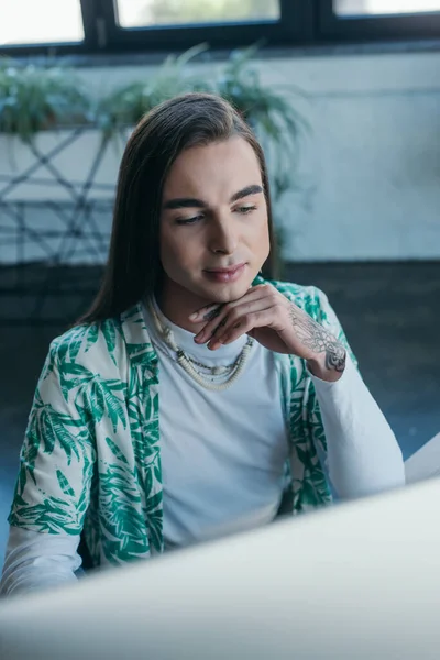 Young queer designer using blurred computer in office — Photo de stock