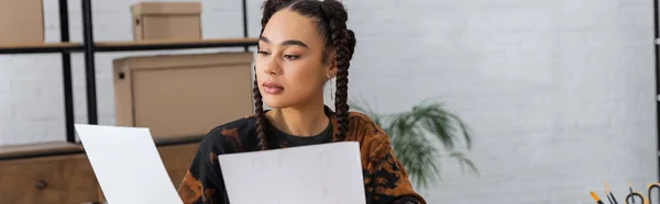 African american designer holding papers in workshop, banner — Stock Photo