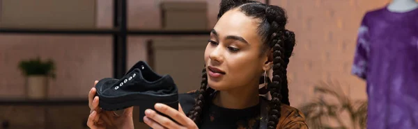 African american craftswoman holding shoe in workshop, banner — Stock Photo