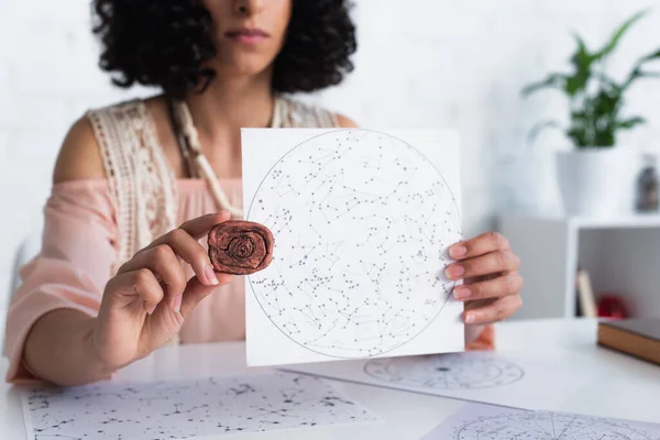 Partial view of oracle holding clay rune and constellations map — Fotografia de Stock