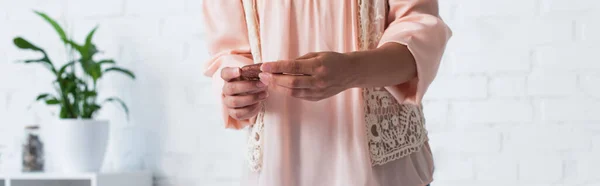 Partial view of soothsayer holding clay rune, banner - foto de stock