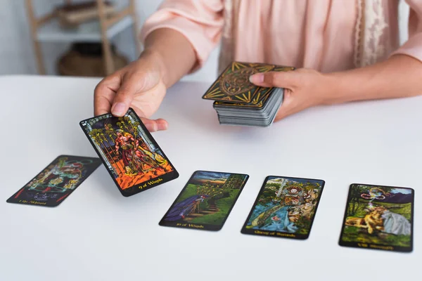 KYIV, UKRAINE - JUNE 29, 2022: partial view of woman predicting on tarot cards at home — Stock Photo