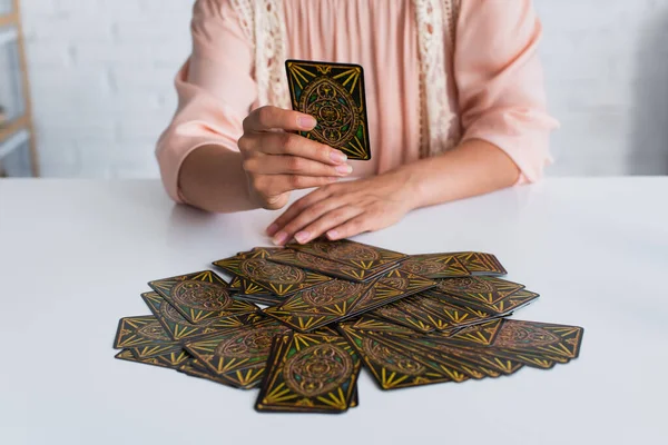KYIV, UKRAINE - JUNE 29, 2022: partial view of deck of tarot cards near soothsayer predicting at home — Foto stock