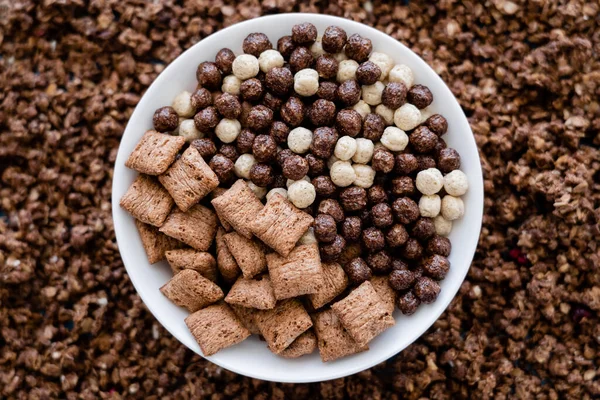 Top view of bowl with tasty cereal balls and puffs near granola — Stock Photo