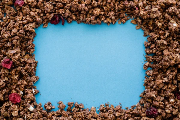 Ansicht des Rahmens aus knusprigem und süßem Hafer-Müsli isoliert auf blau — Stockfoto