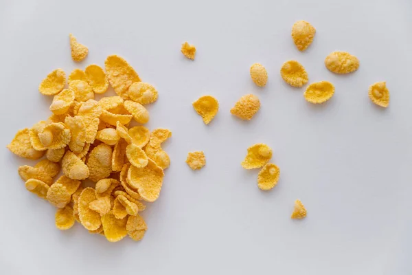 Top view of dry and crispy corn flakes isolated on white — Stock Photo