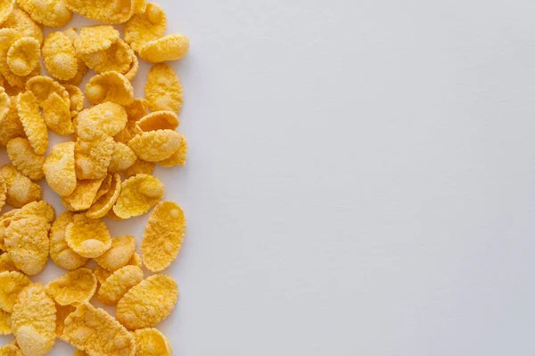 Flat lay of dry and crispy corn flakes isolated on white — Stock Photo