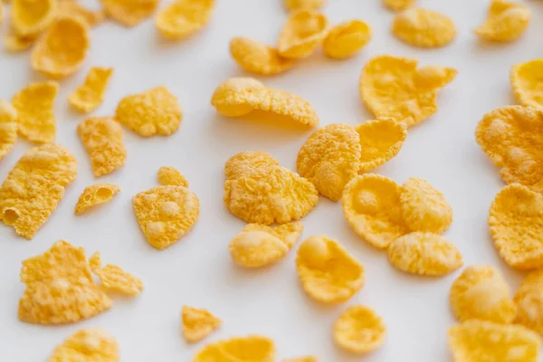 Top view of crispy and dry corn flakes on white background — Stock Photo