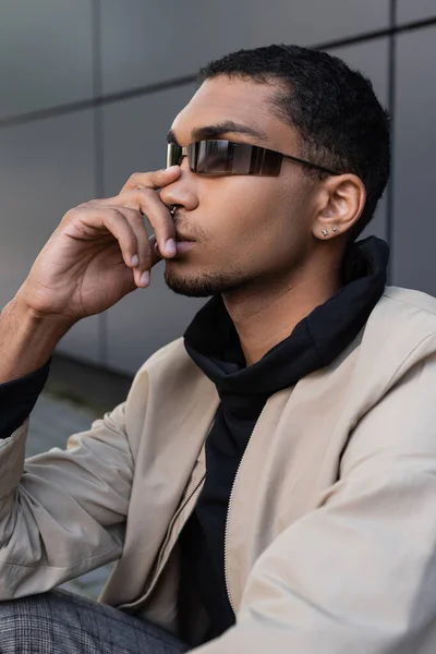 Porträt eines nachdenklichen afrikanisch-amerikanischen Mannes im herbstlichen Outfit und stylischer Sonnenbrille — Stockfoto