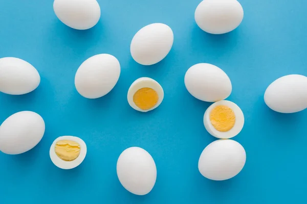 Top view of boiled eggs on blue surface — Stock Photo