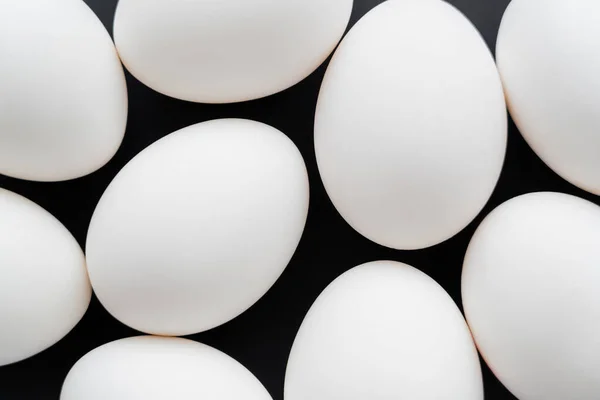 Top view of white chicken eggs isolated on black — Stock Photo