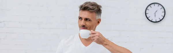 Man in t-shirt holding cup of coffee at home, banner — Stock Photo