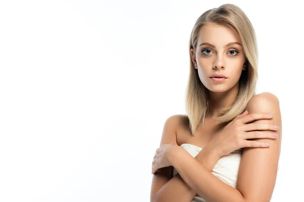 Portrait of blonde woman with natural makeup and bare shoulders posing with crossed arms isolated on white — Stock Photo