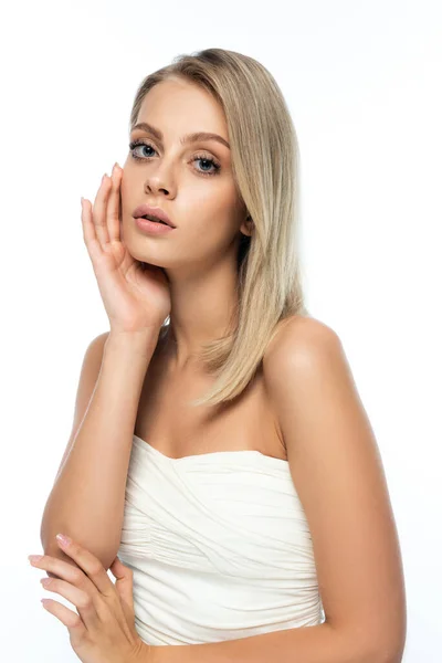 Portrait of blonde woman with blue eyes and bare shoulders looking at camera isolated on white — Stock Photo