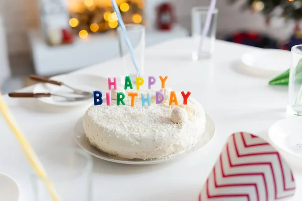 Gâteau d'anniversaire avec des bougies près des verres sur la table à la maison — Photo de stock