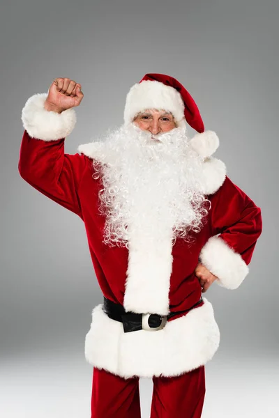 Bearded santa claus showing yes gesture and looking at camera isolated on grey — Stock Photo