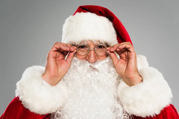 Portrait of santa claus wearing eyeglasses isolated on grey — Stock Photo