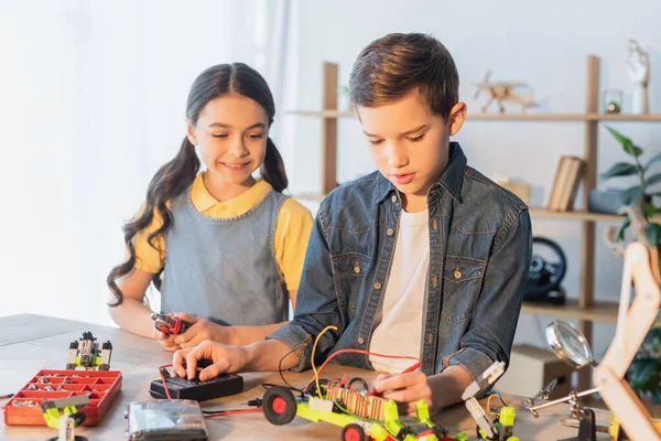 Preteen kids making robotic model at home — Stock Photo