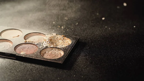 Palette with crushed face powder on black background with copy space — Stock Photo