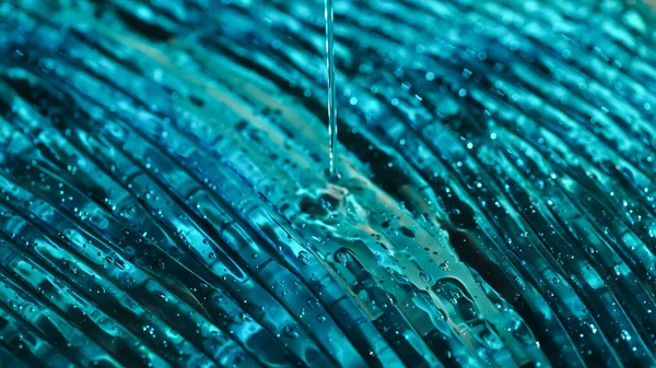 Close up view of blue hydrogel pouring on textured surface — Stock Photo