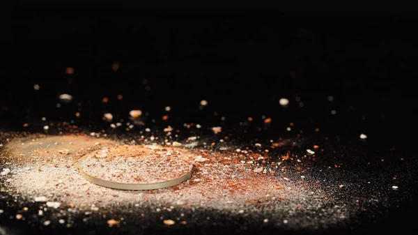 Colorful and cracked face powder on black background with copy space — Stock Photo