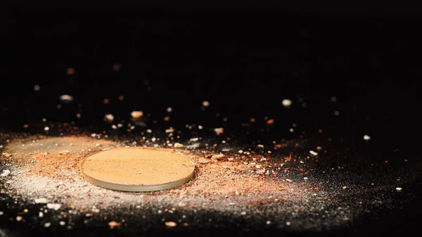 Close up view of crushed face powder on black background — Stock Photo