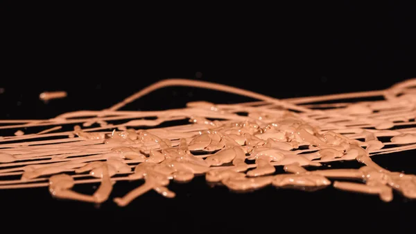 Close up view of blurred makeup concealer on black background — Stock Photo