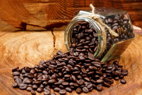 Roasted coffee beans on wood and black coffee Arabica. — Stock Photo, Image