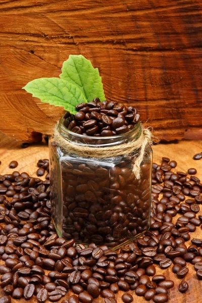 Roasted coffee beans on wood. (Arabica coffee) — Stock Photo, Image