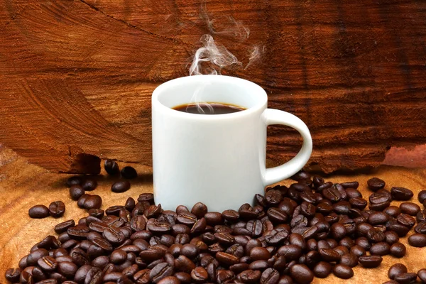 Rostade kaffebönor på trä och svart kaffe. — Stockfoto