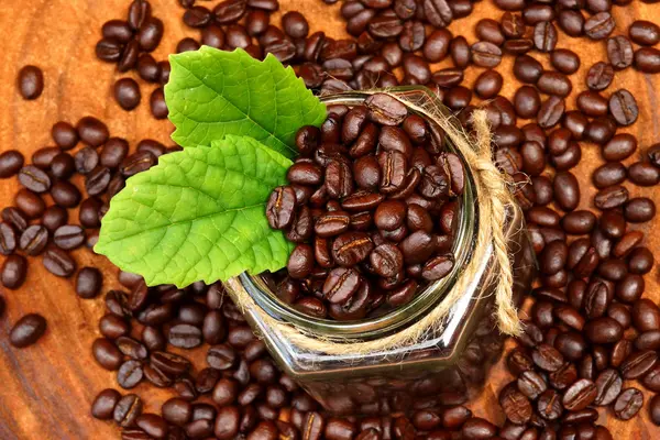 Roasted coffee beans on wood. (Arabica coffee) — Stock Photo, Image