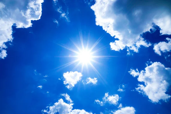 Blue sky with clouds and sun.